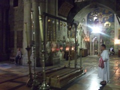 Thomas standing at the site where Jesus' body was prepared for burial. The slab is not the original (at least three slabs have lain there). It's customary to kneel and kiss the slab when entering and leaving the Church.