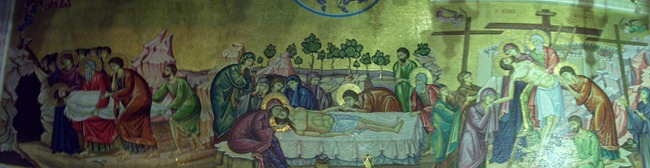 A mosaic behind the slab on which Jesus' body was prepared; this mosaic illustrates three of the major sites commemorated in the Church of the Holy Sepulcher.
