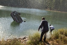 Andrew accidentally pushes a tailgating truck off the road and into a river.