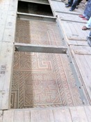 The original 4th century mosaic tile floors, under trap doors to keep them safe.